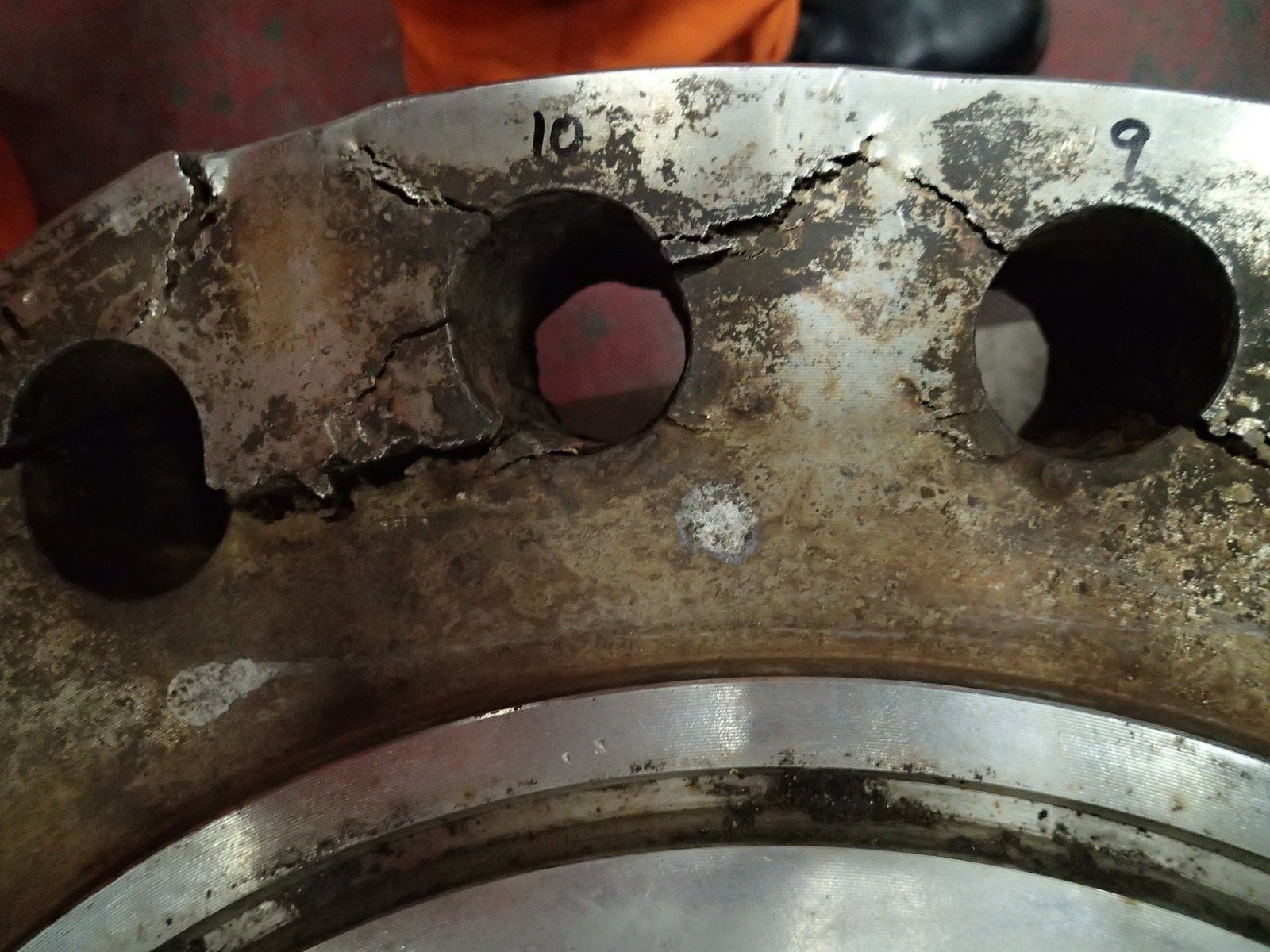 Cracked ligaments between bolt holes on a failed flange face