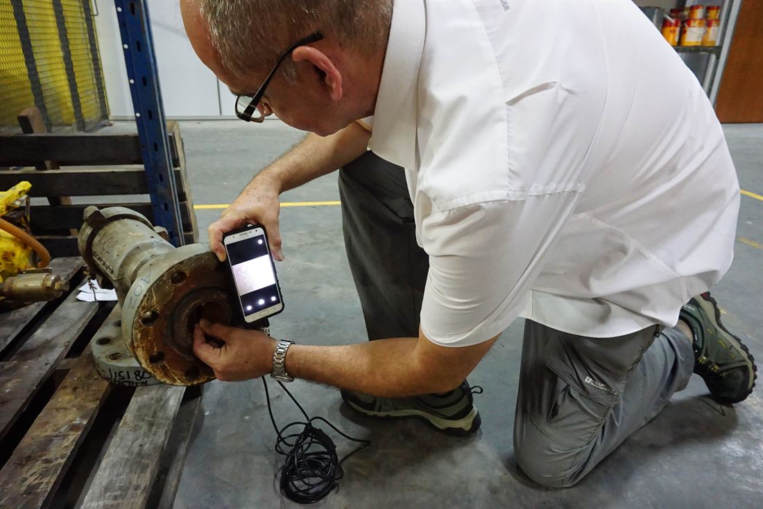 MTIS engineer inspecting a component bore with a borescope