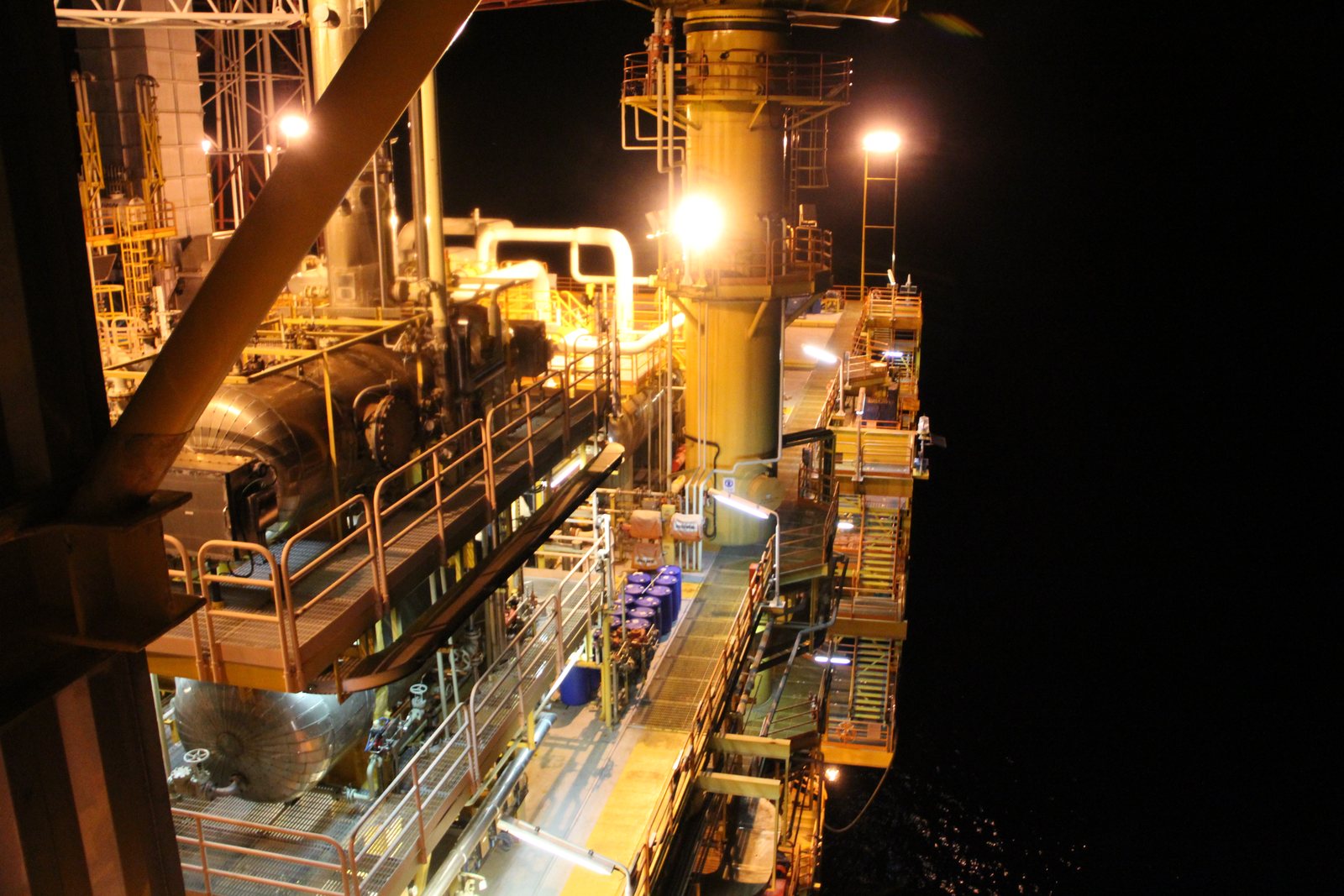 Offshore oil and gas production platform lit at night